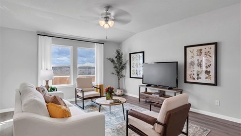 Creekfall model home living room with view of the back yard.