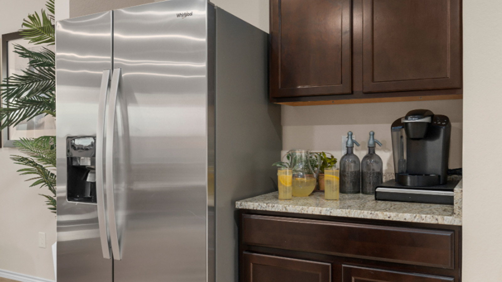 Yowell Ranch Model Home kitchen with dark cabinets and granite countertops.