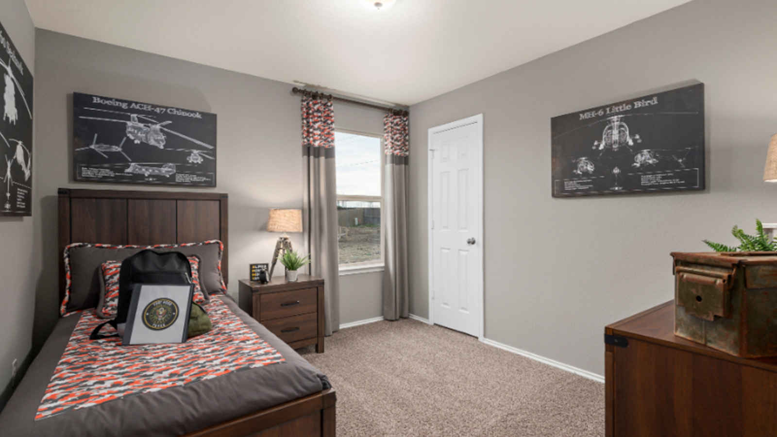 Yowell Ranch Model Home secondary bedroom with carpeted flooring and windows for lighting.