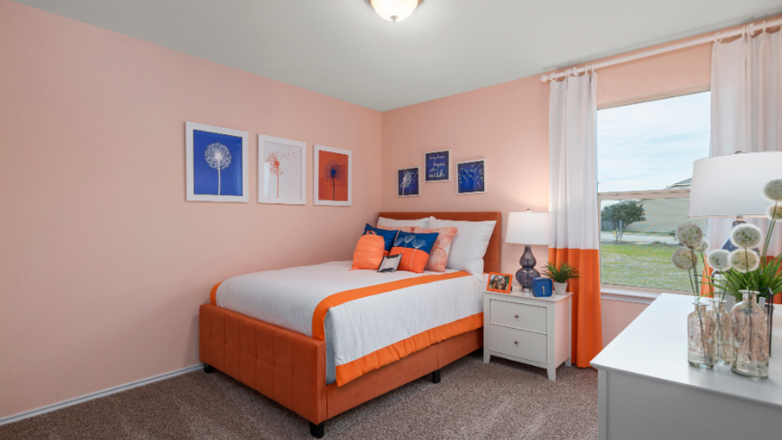 Yowell Ranch Model Home secondary bedroom with carpeted flooring and windows for lighting.