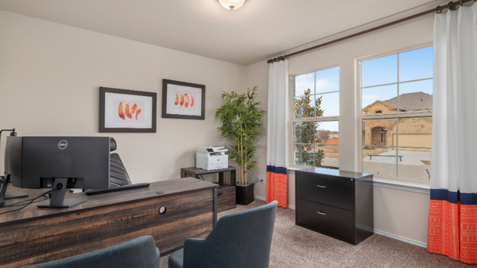 Yowell Ranch Model Home secondary bedroom with carpeted flooring and windows for lighting.