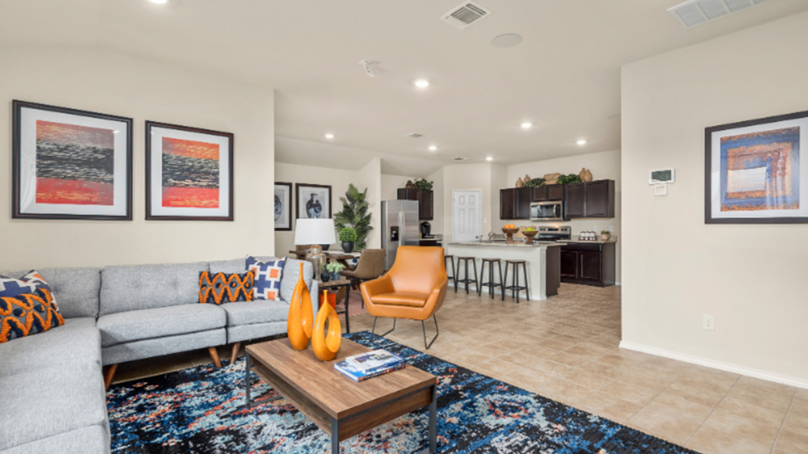 Yowell Ranch Model Home living room with view of open concept dining room and kitchen.