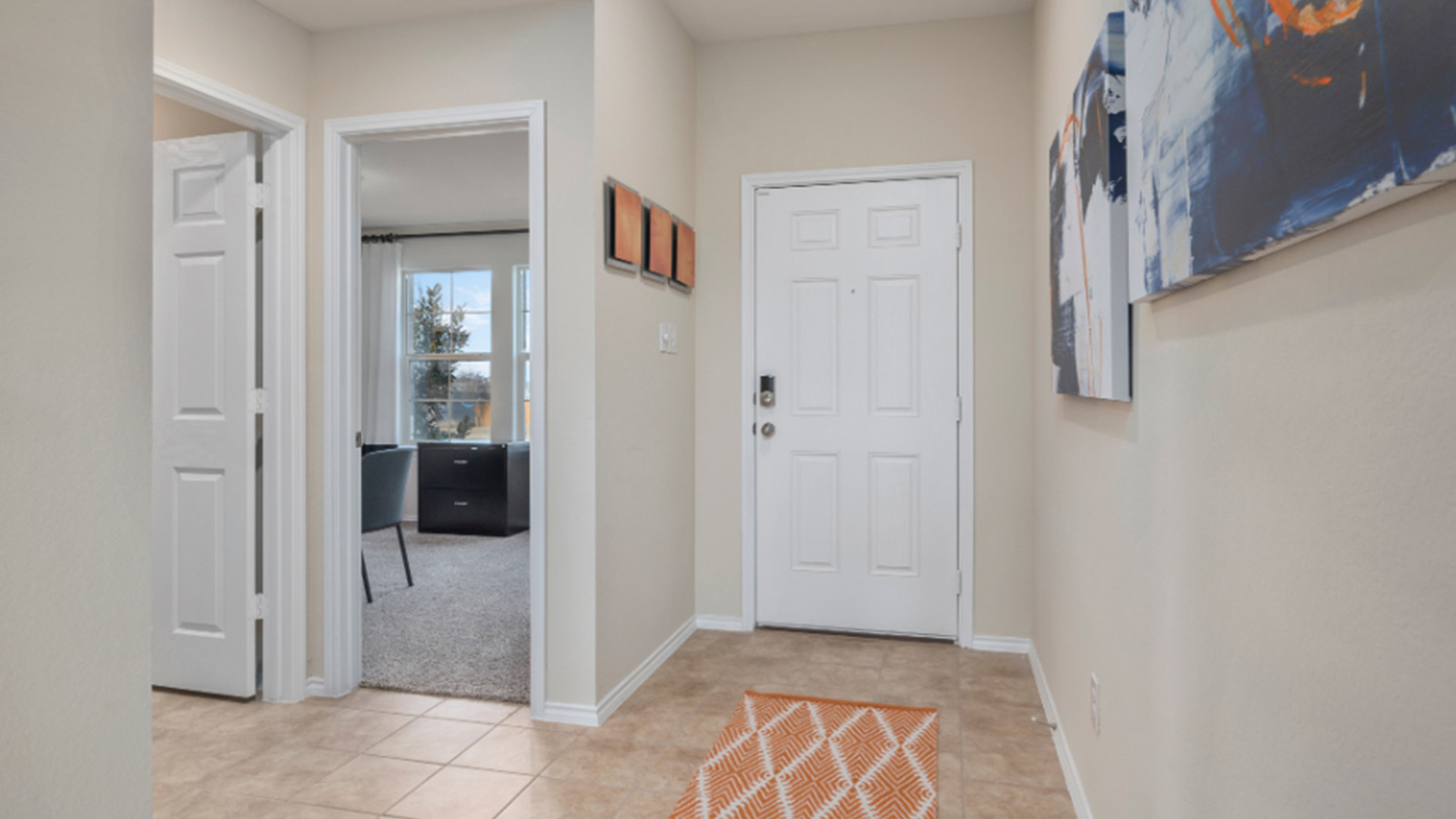 Yowell Ranch Model Home front entrance hallway with view of secondary bedroom and front door.