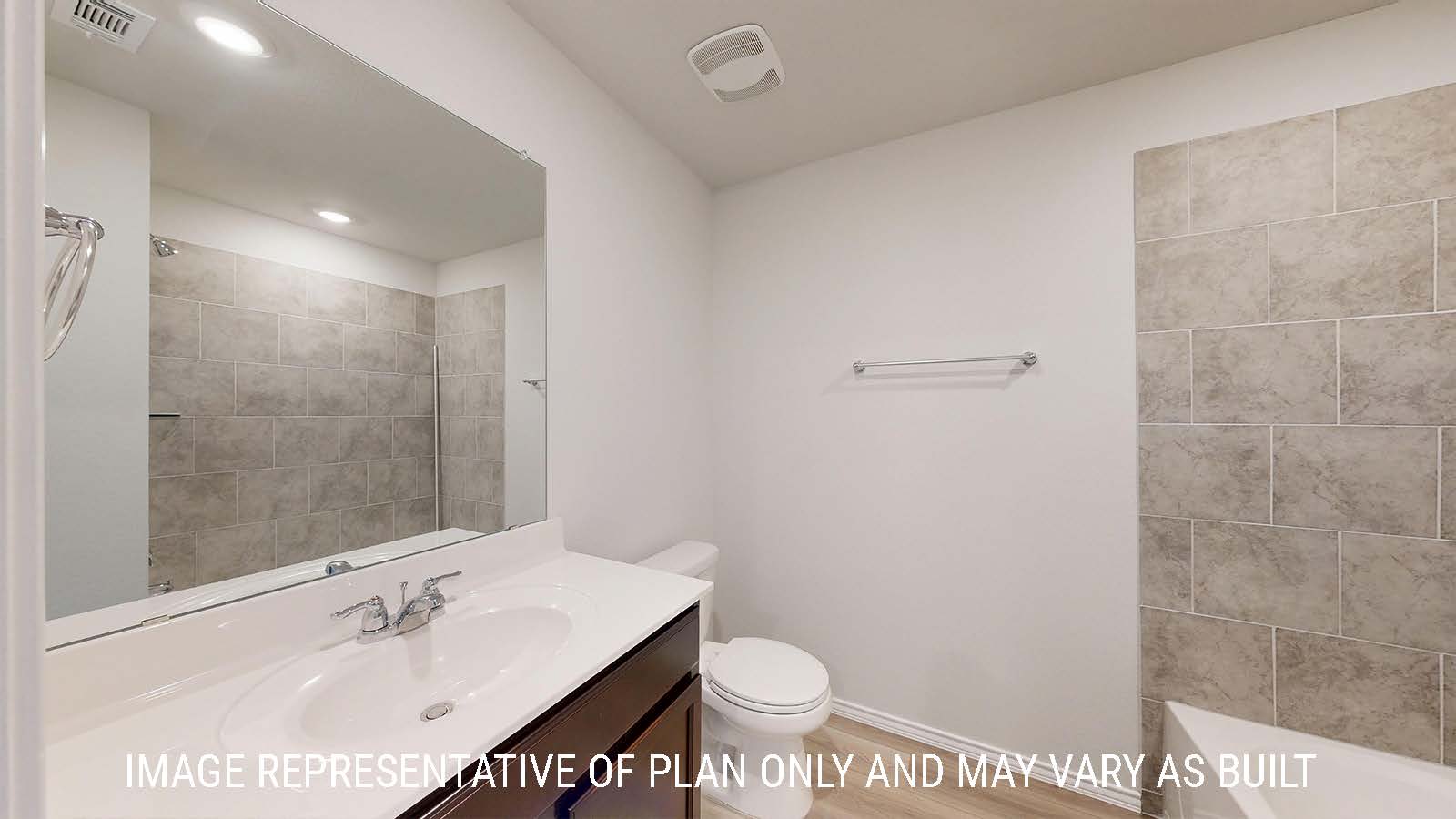 Caden secondary bathroom with vanity sink and dark cabinets.