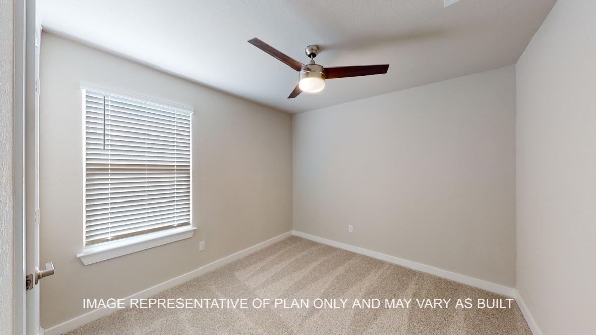 Caden secondary bedroom with carpet flooring and window.