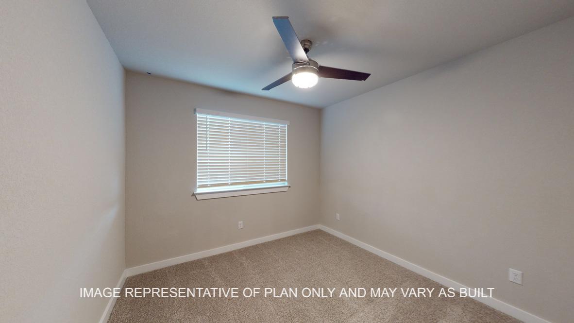 Caden secondary bedroom with carpet flooring and window.