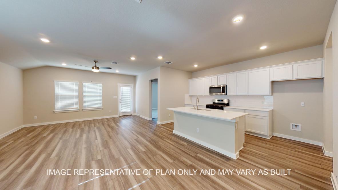 Caden open concept kitchen and living and dining areas.