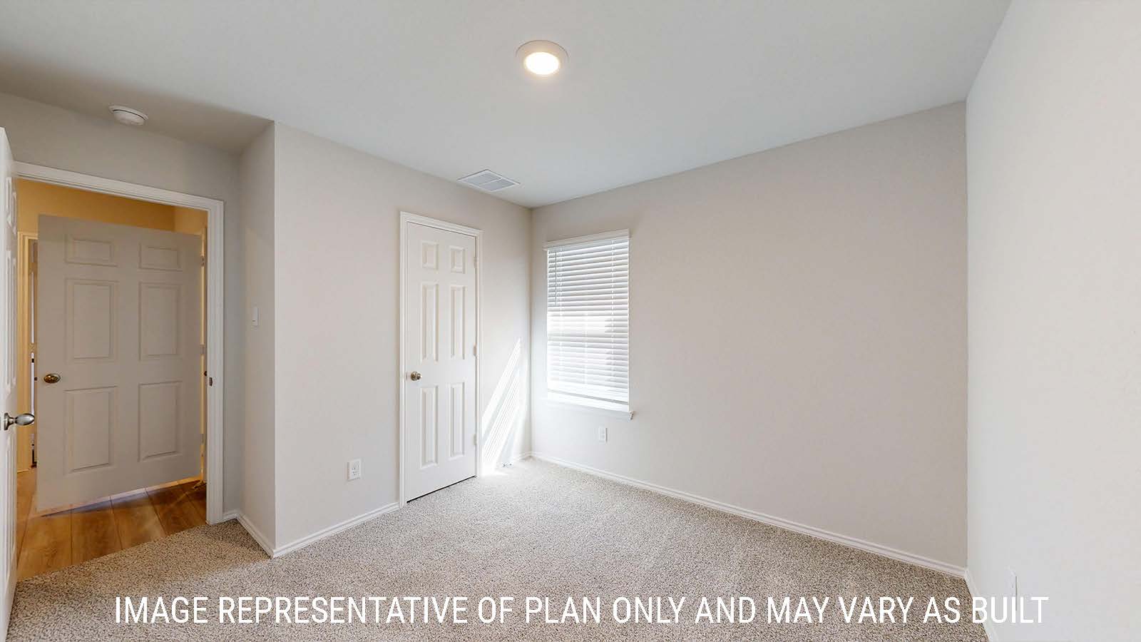 Gaven secondary bedroom with carpeted flooring and window for natural lighting.
