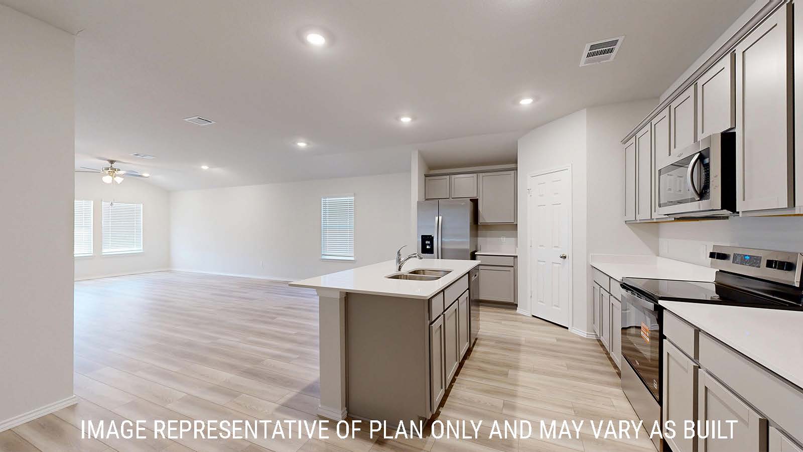 Gaven kitchen with kitchen island and view of open concept living room and dining room.