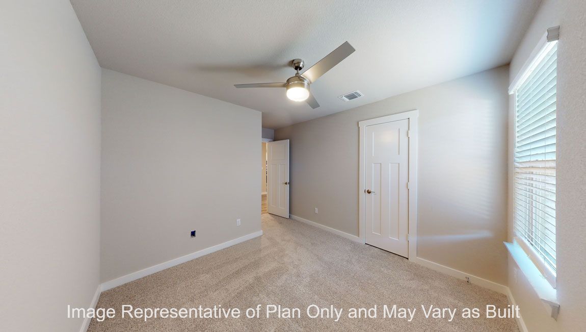 Harris secondary bedroom with carpet flooring and window.