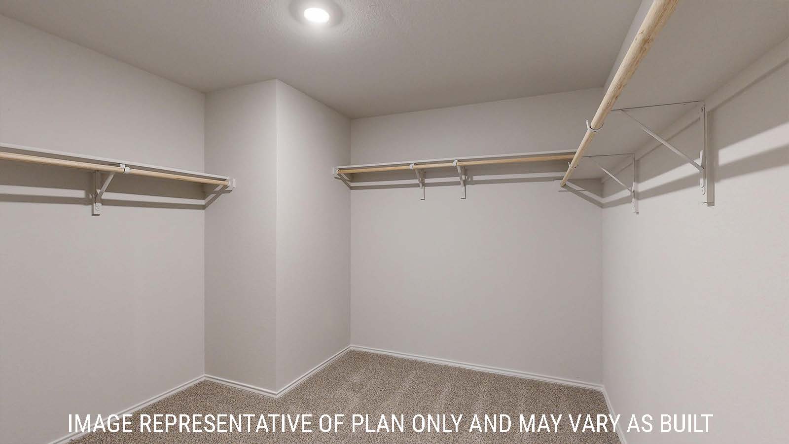 Harris primary closet with carpeted flooring and shelving for storage.