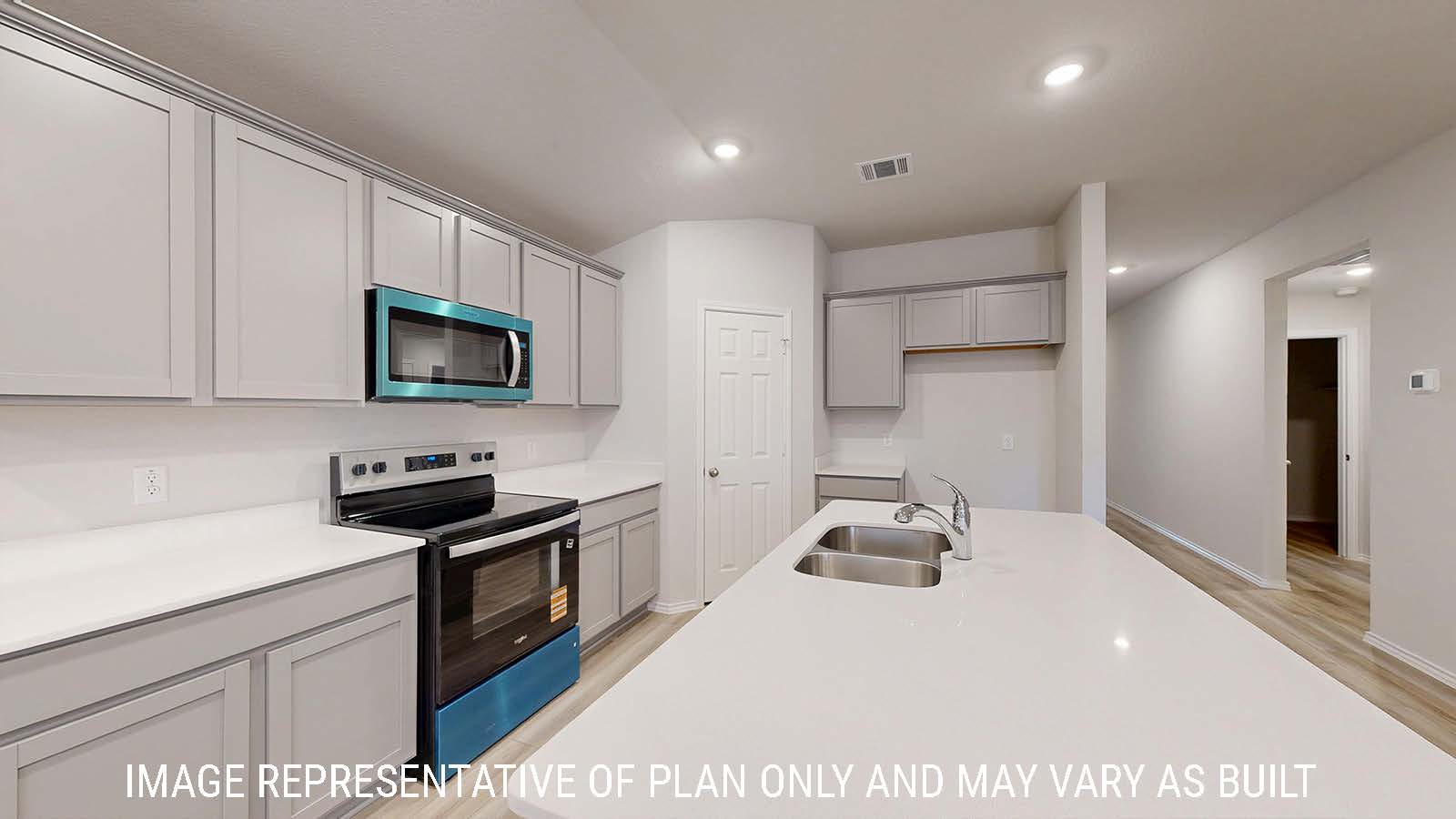 Harris kitchen with light cabinets and light countertops with view of front hallway.