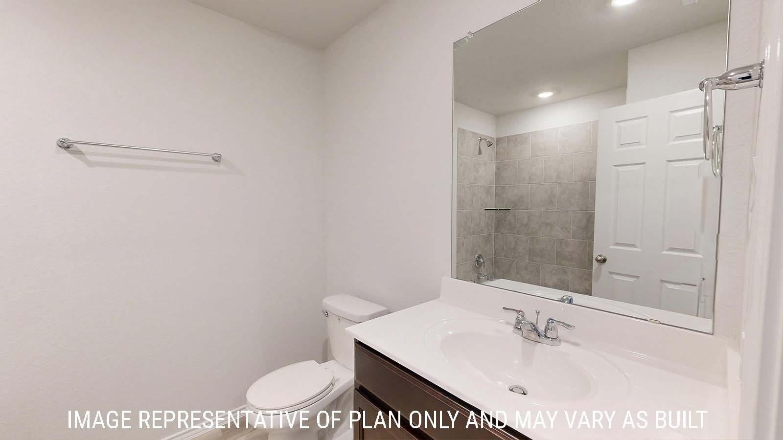 Harris secondary bathroom with vanity sink and dark cabinets.