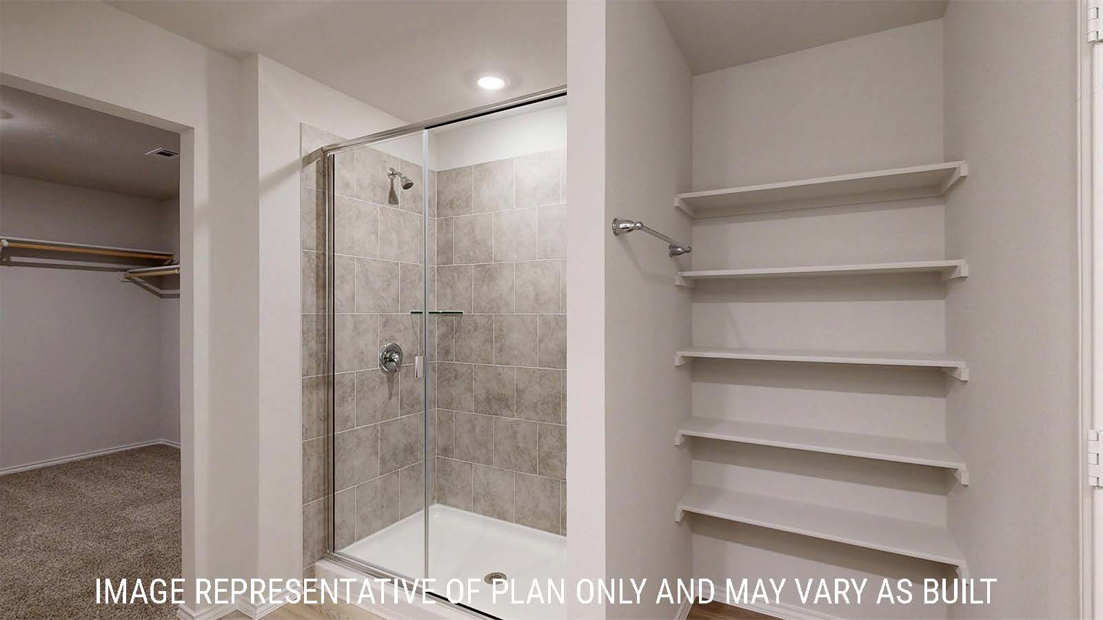 Harris primary bathroom with walk-in shower and shelving for storage.