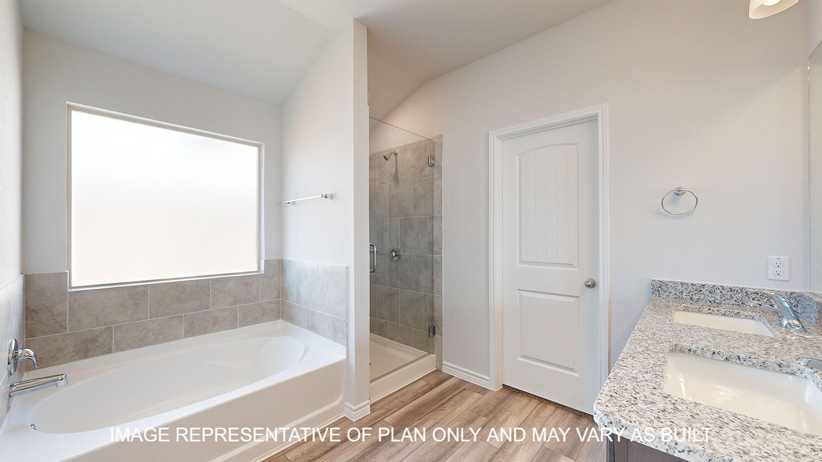 Alpine primary bath with separate tub and shower with clear glass enclosure and ceramic tile surround.