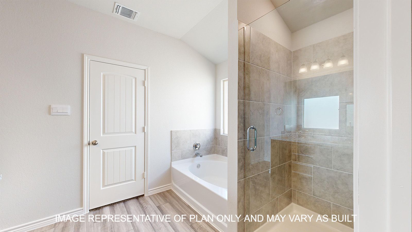 Alpine primary bath with separate tub and shower with clear glass enclosure and ceramic tile surround.