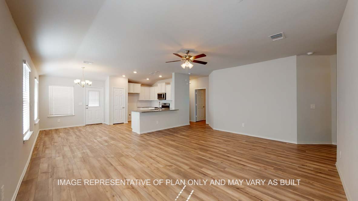 Roosevelt living room with vinyl plank flooring and view into kitchen.