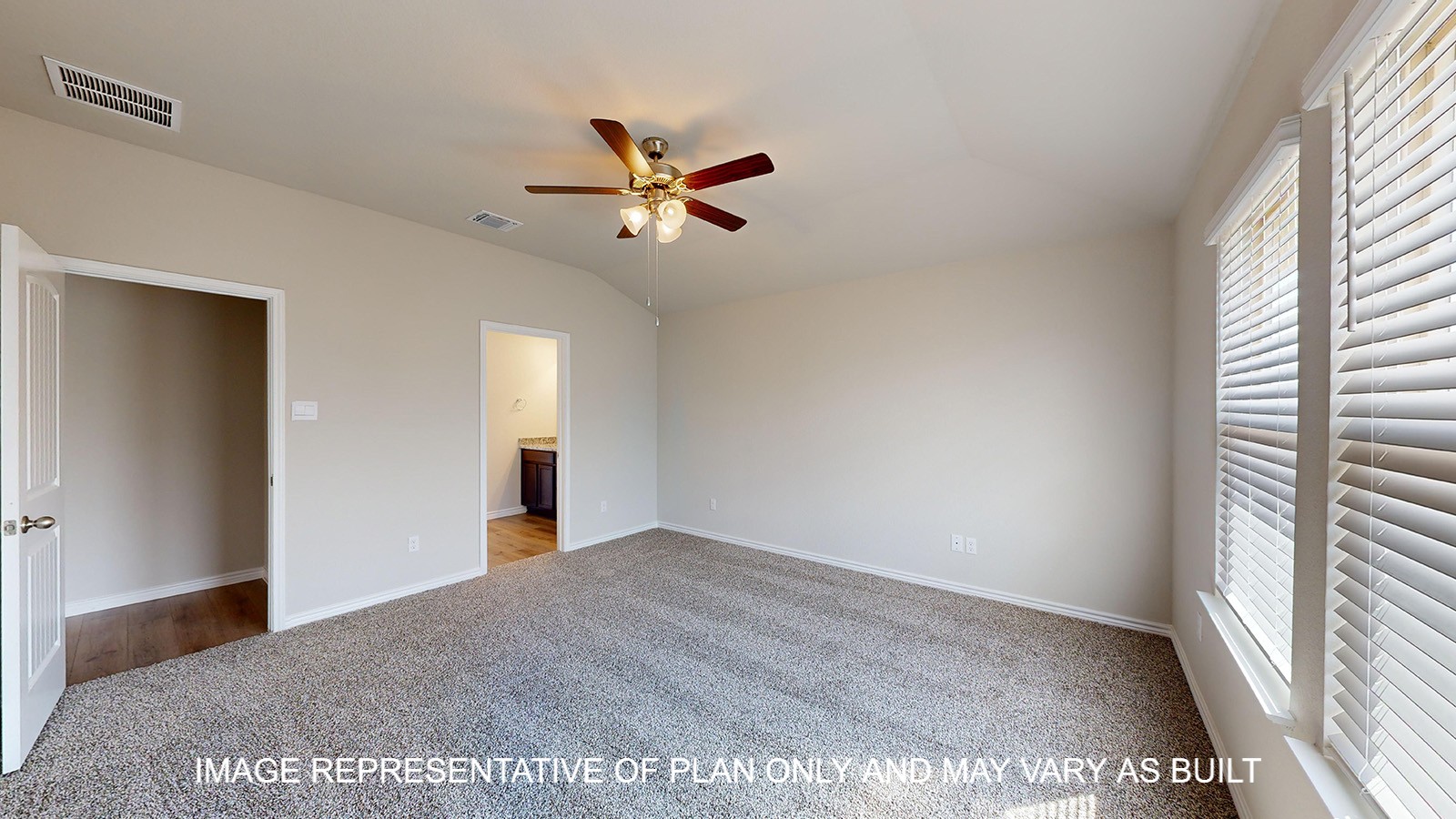 Monroe primary bedroom with carpet flooring and ceiling fan.