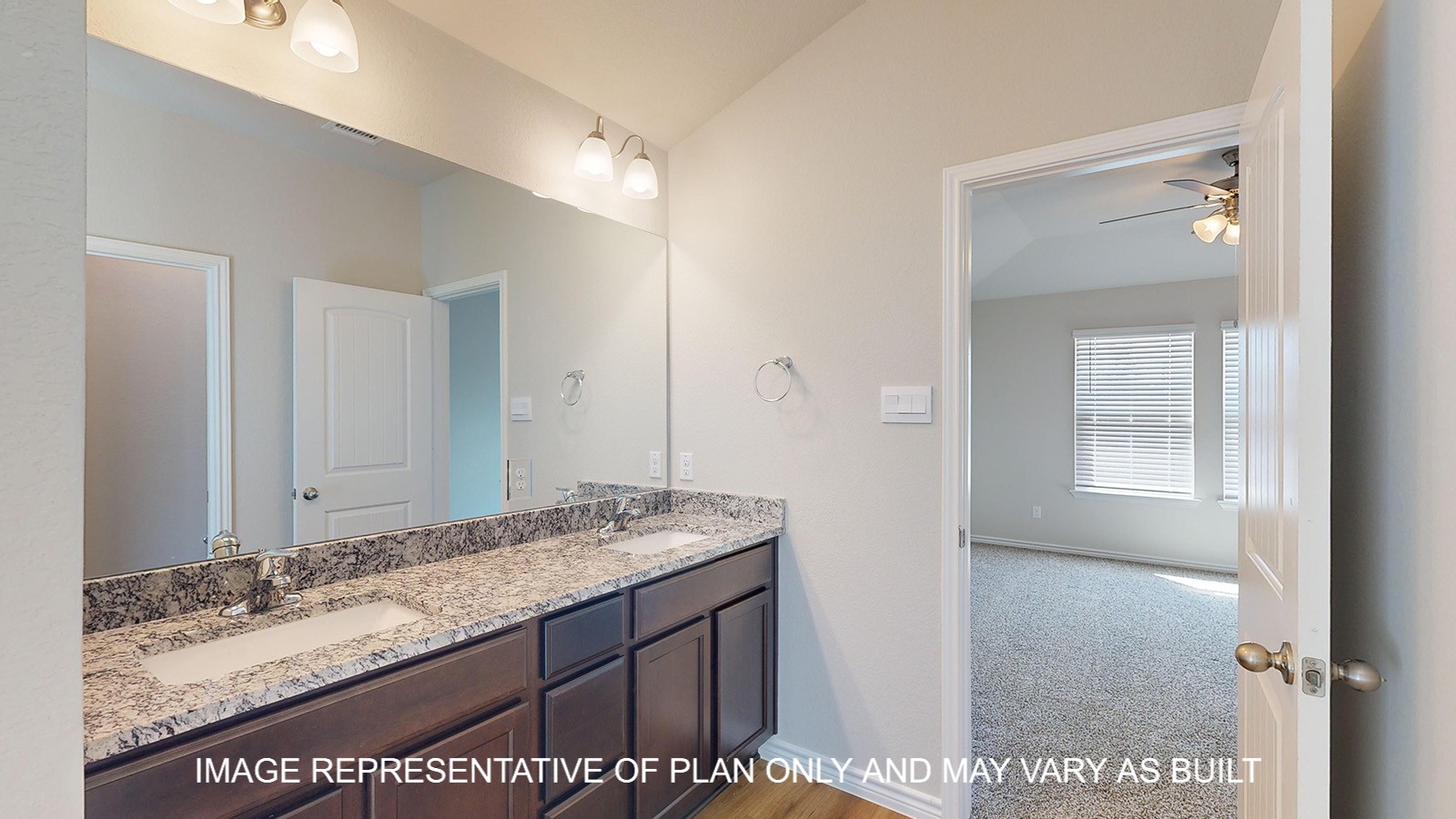 Monroe primary bathroom with granite countertops and dual vanities.