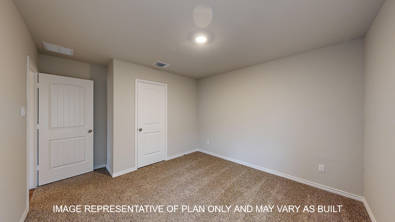 Monroe secondary bedroom with carpet flooring and closet door.