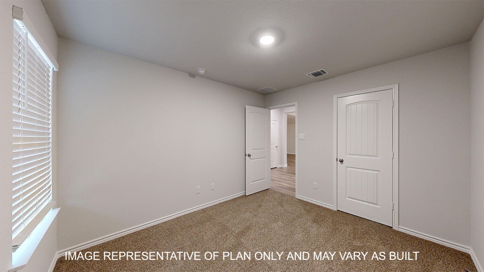 Everett secondary bedroom with carpet flooring and closet door.