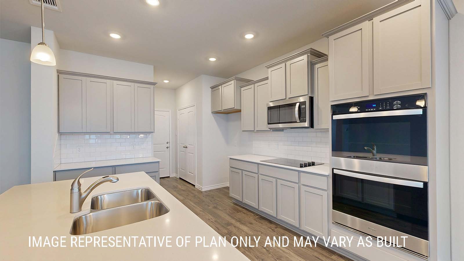 Sonoma kitchen with center kitchen island and light cabinets and granite countertops.