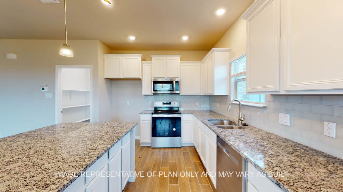 Kiawa kitchen with white cabinets and granite countertops.
