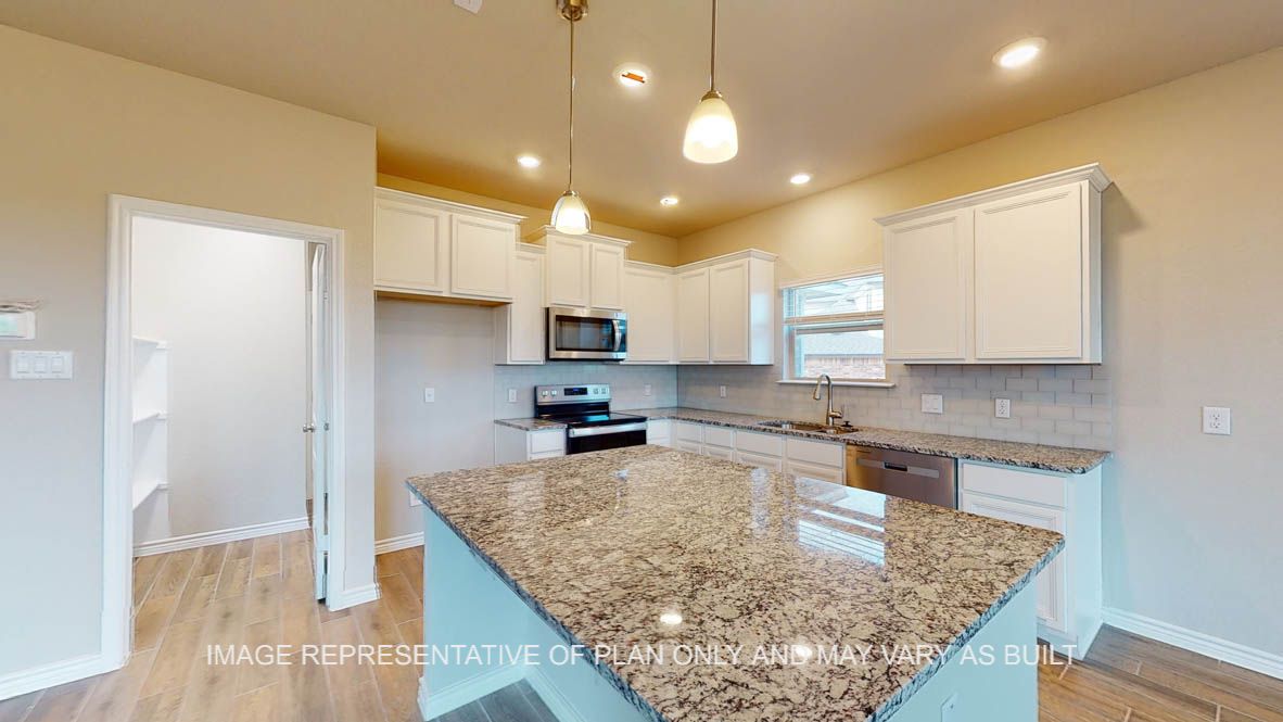 Kiawa kitchen with center kitchen island and granite countertops.