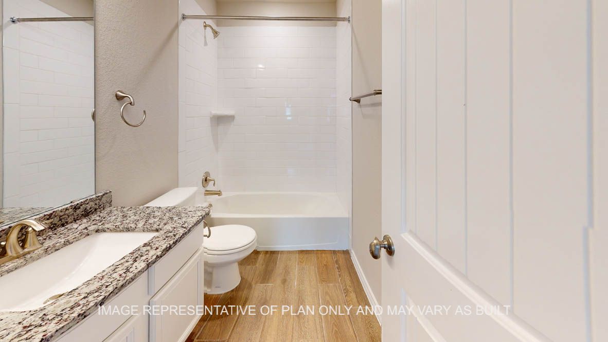 Kiawa secondary bathroom downstairs with white cabinets and granite countertops.