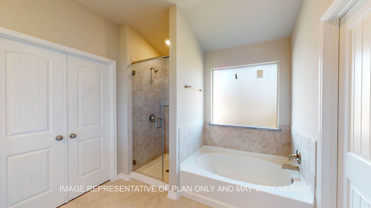 Kiawa primary  bathroom separate tub and shower with ceramic tile surround.