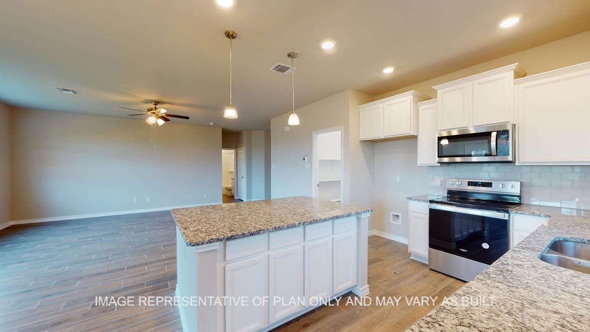 Kiawa kitchen with center kitchen island and granite countertops.
