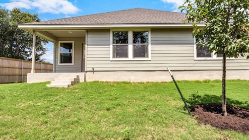 Three Creeks Colt Creek model home backyard with a view of the back door.