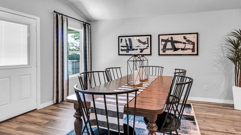 Three Creeks Colt Creek model home dining room with view of the back door.