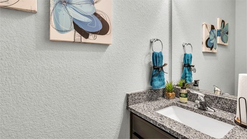 Three Creeks Colt Creek model home half bath single vanity sink and mirror.