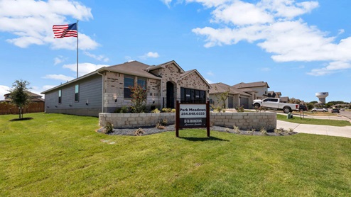 Park Meadows model home exterior elevation with brick garden.