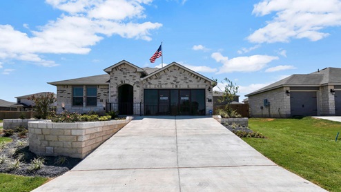 Park Meadows model home exterior elevation with glass store front windows.