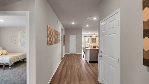 Park Meadows model home entry with view into secondary bedroom.