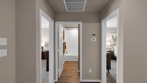 Park Meadows model home hallway entry with view into secondary bedrooms and bathroom.