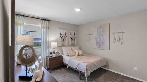 Parks Meadows model home secondary bedroom with a twin bed and accent decor.