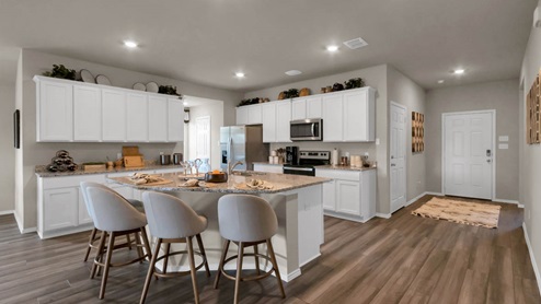 Park Meadows model home kitchen with view of the front door.