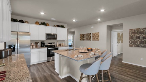 Park Meadows model home kitchen with view of secondary and primary bedrooms.