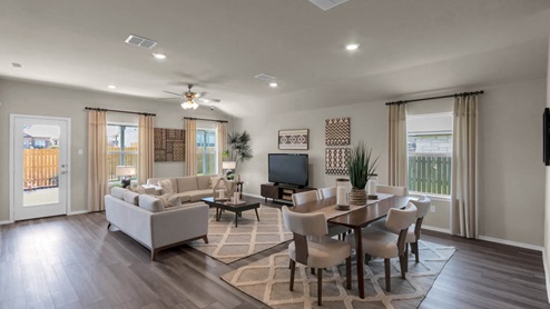 Park Meadows model home dining room with view of the living room.