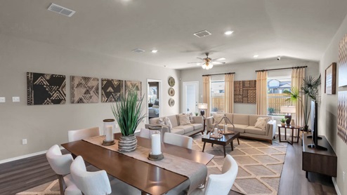 Park Meadows model home dining room with view of the living room.