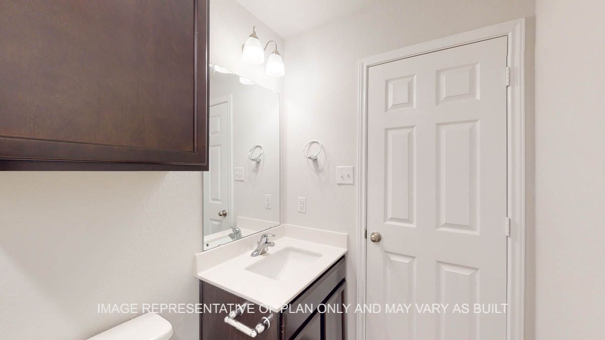 Prescott secondary bathroom with dark cabinets and single vanity.