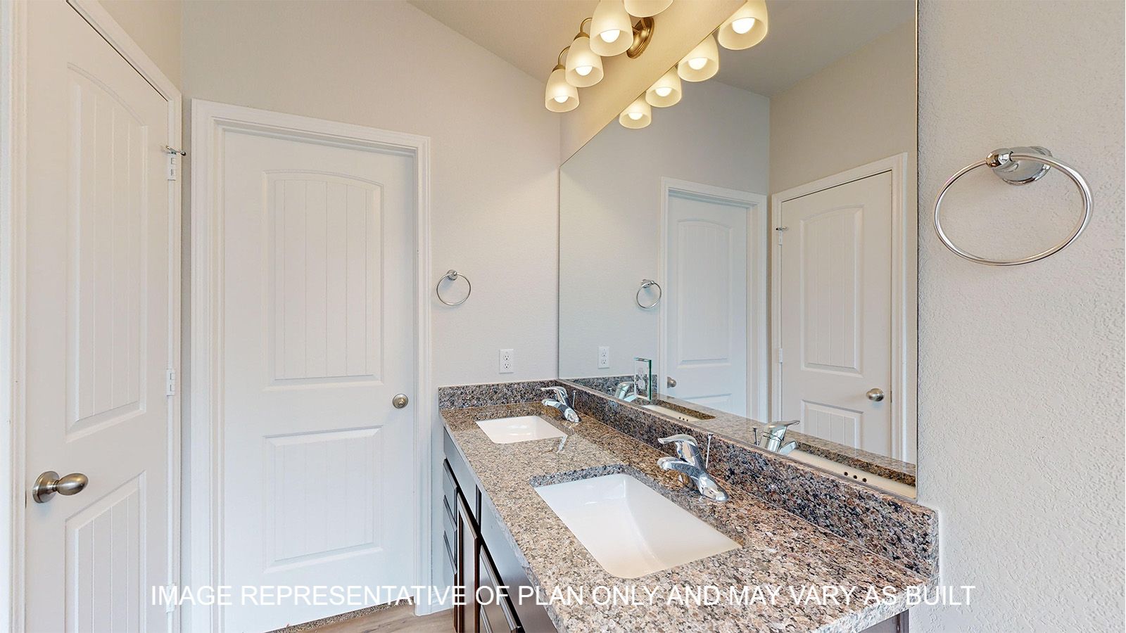 Magnolia bath with dual vanities and granite countertops.