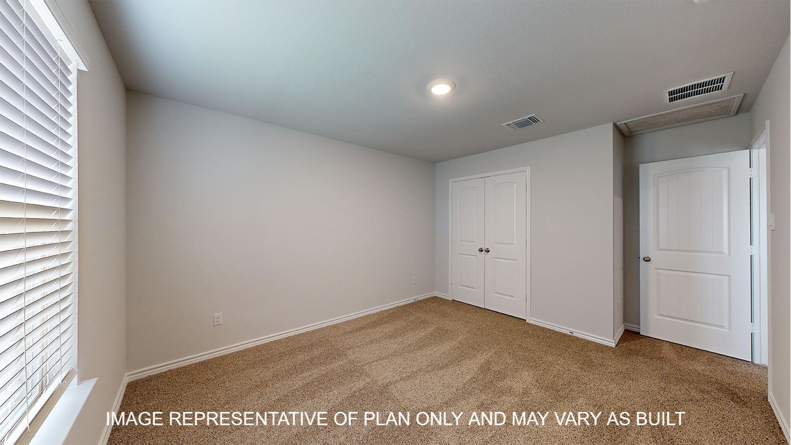 Magnolia secondary bedroom with carpet flooring and closet doors.