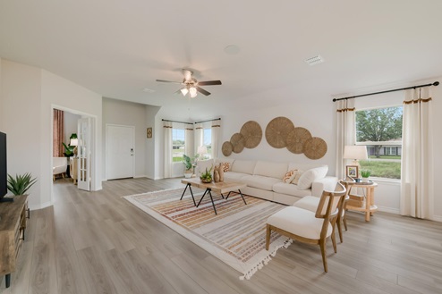 Foxborough model home living room with view into the secondary bedroom.