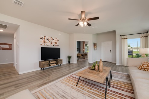 Foxborough model home living room with view into the secondary bedroom and hallway.