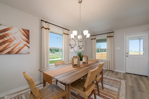 Foxborough model home dining room table and view to the backyard.
