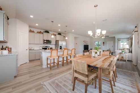 Foxborough model home dining room open concept with the living room and kitchen.